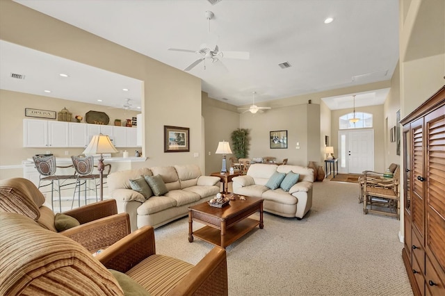 living room with recessed lighting, visible vents, a ceiling fan, and light carpet