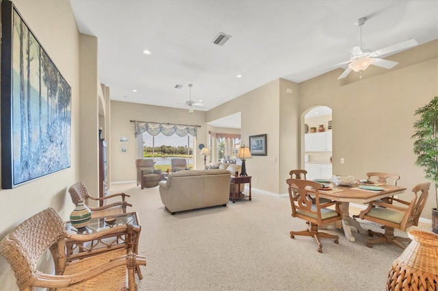 living room with a ceiling fan, arched walkways, baseboards, visible vents, and recessed lighting