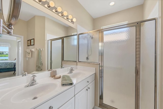 bathroom with a sink, a shower stall, double vanity, and connected bathroom