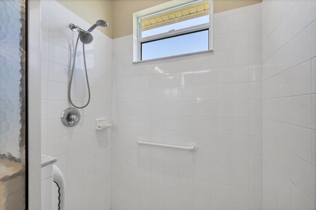 bathroom with a tile shower