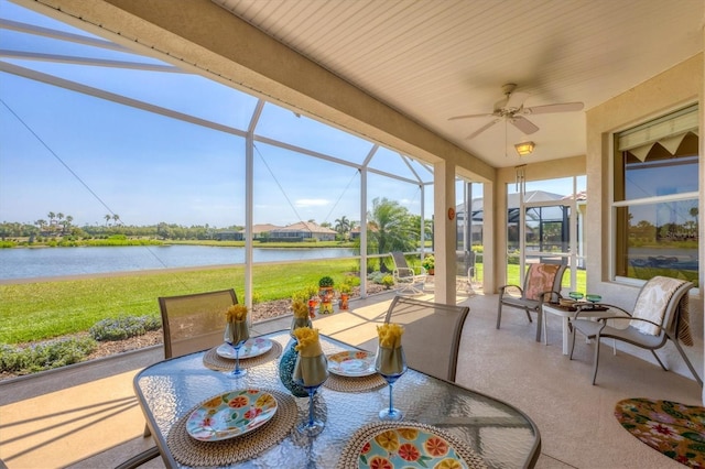 sunroom / solarium with ceiling fan, outdoor dining space, and a water view