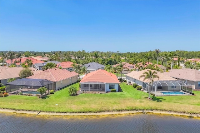drone / aerial view with a residential view and a water view