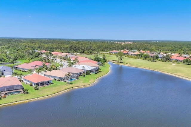 aerial view with a forest view and a water view