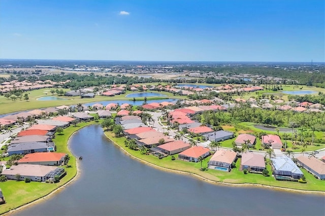 birds eye view of property featuring view of golf course, a residential view, and a water view