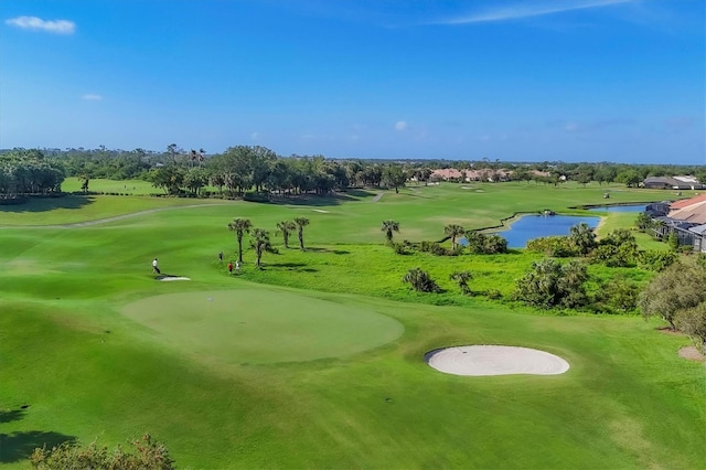 view of property's community with view of golf course and a water view