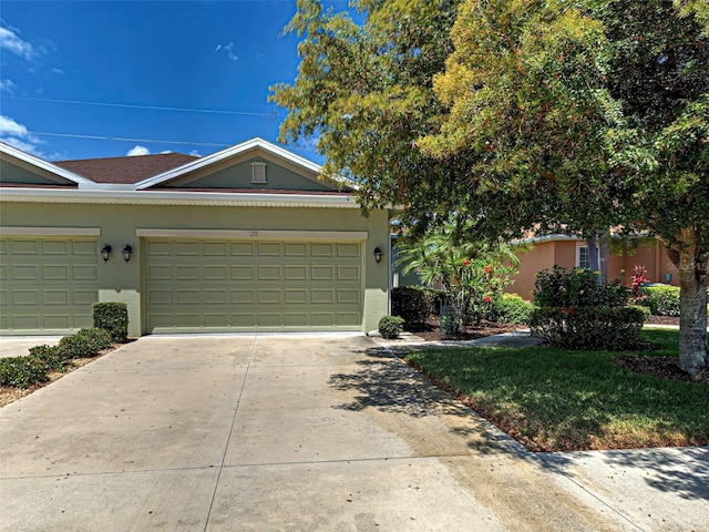 view of front of home featuring a garage, stucco siding, and driveway