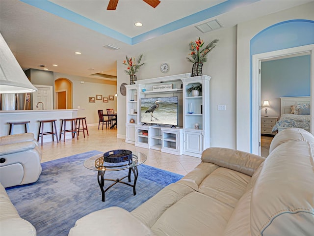 living area featuring recessed lighting, a ceiling fan, visible vents, baseboards, and arched walkways