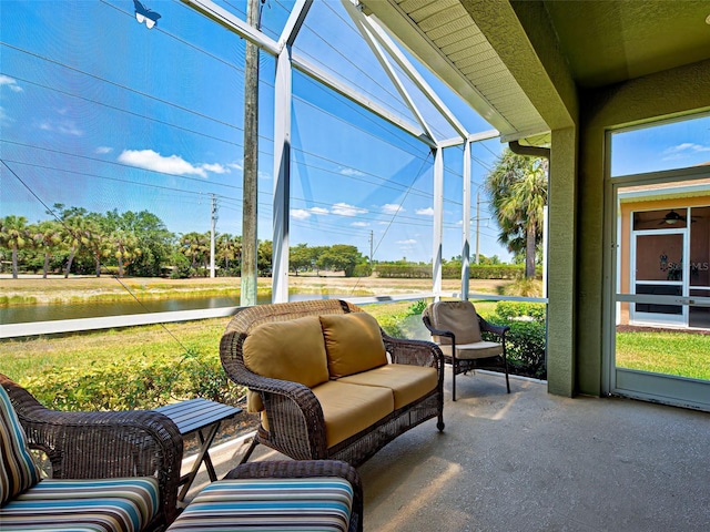sunroom / solarium featuring outdoor lounge area and a water view