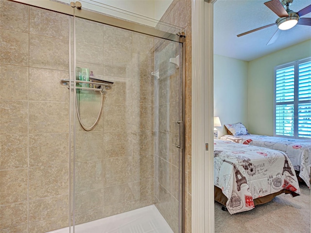 bathroom with connected bathroom, a ceiling fan, and a stall shower