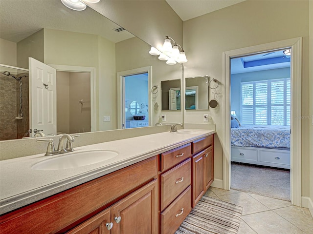 full bath featuring tile patterned floors, double vanity, ensuite bath, and a sink