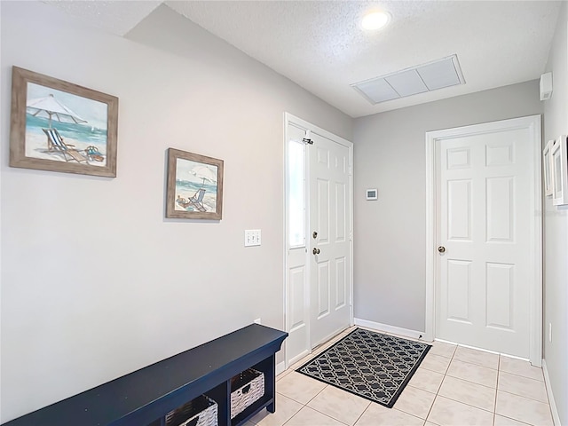 542 Clubside Cir Unit 20, Venice, FL 34293 - entryway with baseboards, visible vents, light tile patterned floors, and a textured ceiling