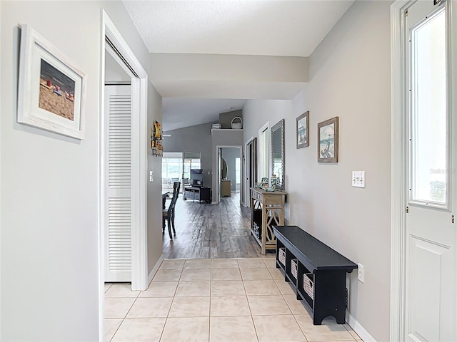542 Clubside Cir Unit 20, Venice, FL 34293 - hallway featuring baseboards, light tile patterned floors, and lofted ceiling