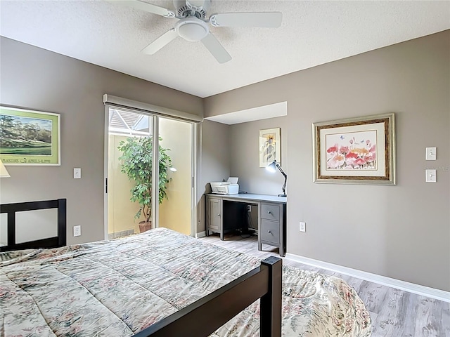 542 Clubside Cir Unit 20, Venice, FL 34293 - bedroom featuring a textured ceiling, light wood-style floors, ceiling fan, baseboards, and access to outside