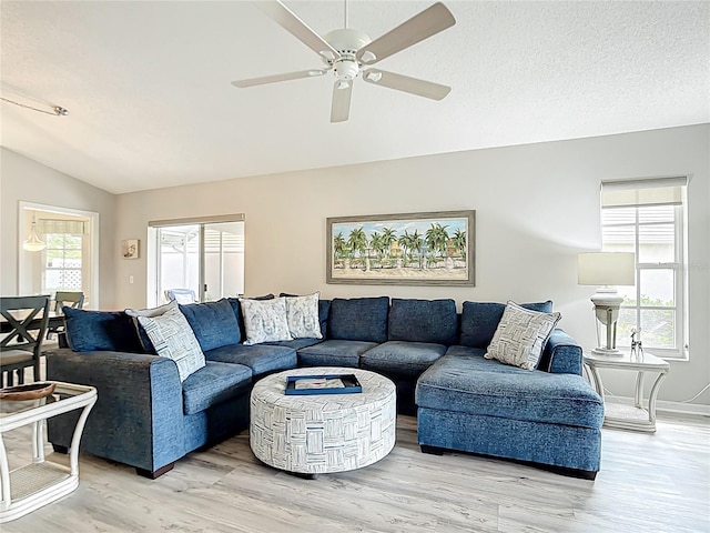 542 Clubside Cir Unit 20, Venice, FL 34293 - living room featuring a ceiling fan, light wood-style flooring, vaulted ceiling, and baseboards