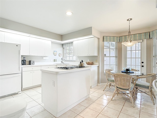 542 Clubside Cir Unit 20, Venice, FL 34293 - kitchen with light tile patterned flooring, stainless steel gas stovetop, light countertops, and freestanding refrigerator