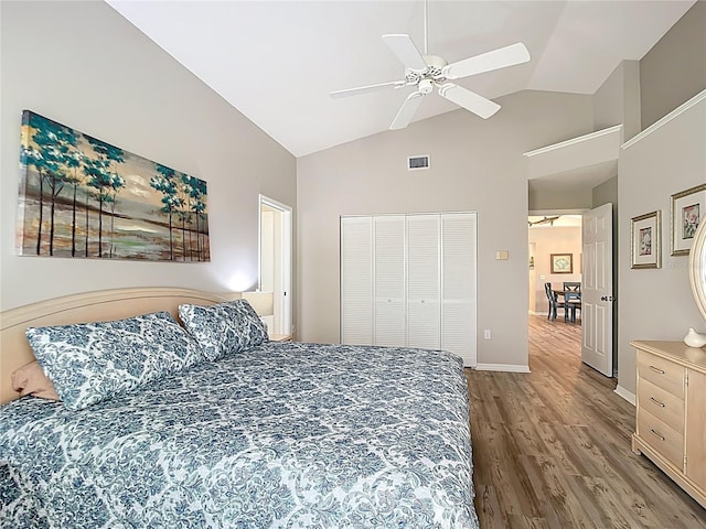 542 Clubside Cir Unit 20, Venice, FL 34293 - bedroom featuring visible vents, a closet, wood finished floors, a ceiling fan, and high vaulted ceiling