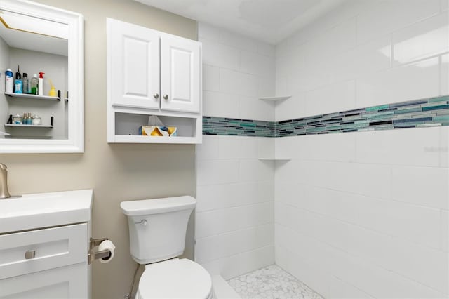 649 Tamiami Trl S Unit 106, Venice, FL 34285 - full bathroom featuring vanity, a tile shower, and toilet
