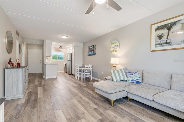 649 Tamiami Trl S Unit 106, Venice, FL 34285 - living room with baseboards, a ceiling fan, light wood-style flooring, and visible vents