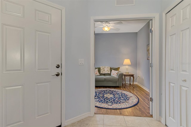 entrance foyer featuring a ceiling fan, baseboards, visible vents, and light tile patterned floors