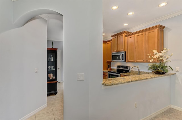 kitchen featuring light stone countertops, appliances with stainless steel finishes, brown cabinetry, recessed lighting, and light tile patterned floors