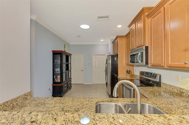 kitchen with visible vents, crown molding, light stone counters, a sink, and appliances with stainless steel finishes