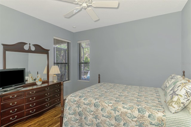 bedroom with baseboards, ceiling fan, and wood finished floors