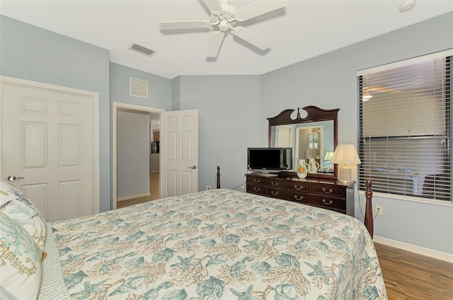 bedroom with visible vents, baseboards, ceiling fan, and wood finished floors