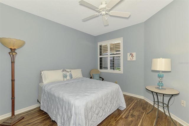 bedroom featuring baseboards, ceiling fan, and wood finished floors