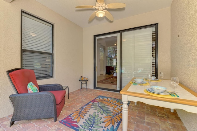 exterior space featuring a ceiling fan