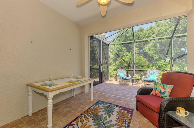 sunroom / solarium with a ceiling fan