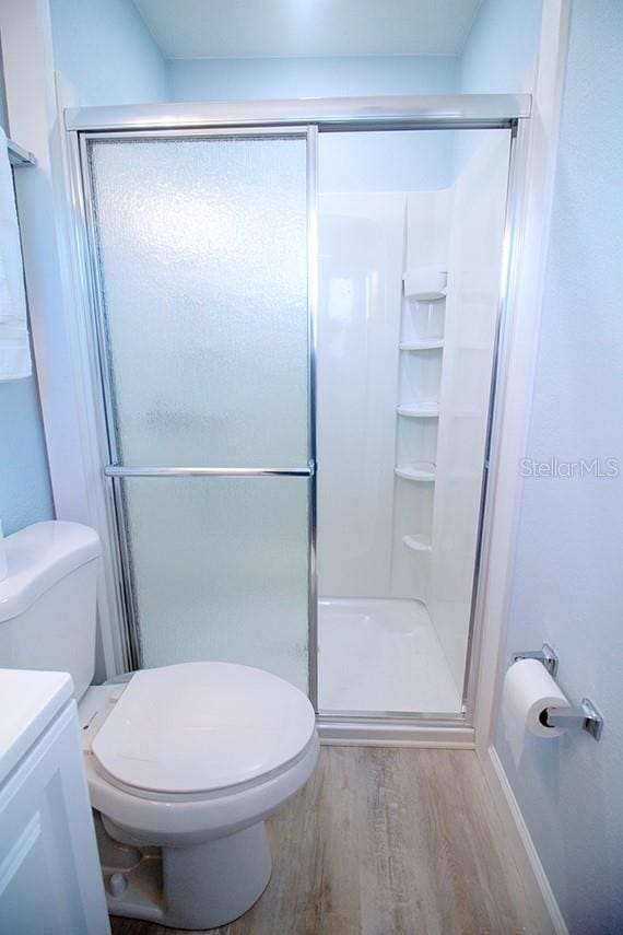 400 Base Unit 225, Venice, FL 34293 - full bath featuring wood finished floors, toilet, a shower stall, and vanity