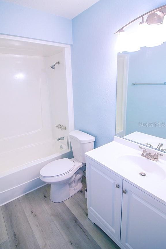400 Base Unit 225, Venice, FL 34293 - full bathroom with wood finished floors, toilet, vanity, and washtub / shower combination