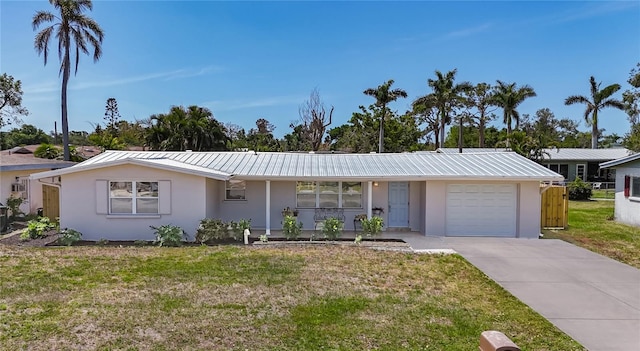 2108 Lee Ln, Sarasota, FL 34231 - single story home with stucco siding, a garage, and metal roof