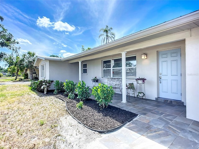 2108 Lee Ln, Sarasota, FL 34231 - doorway to property featuring stucco siding and a porch