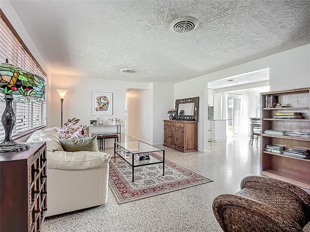 2108 Lee Ln, Sarasota, FL 34231 - living room featuring speckle patterned floor and a textured ceiling