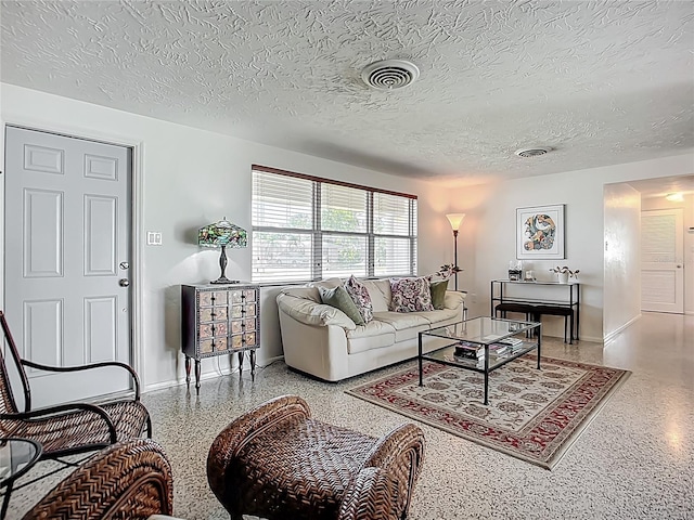 2108 Lee Ln, Sarasota, FL 34231 - living area featuring speckled floor, baseboards, and a textured ceiling