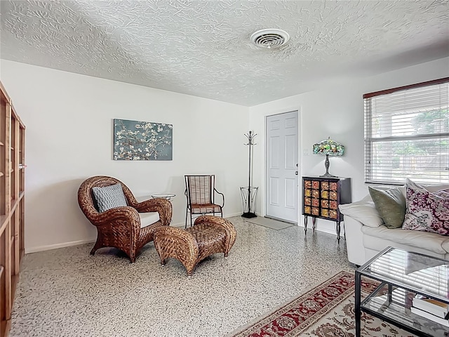 2108 Lee Ln, Sarasota, FL 34231 - living area with speckled floor, baseboards, and a textured ceiling