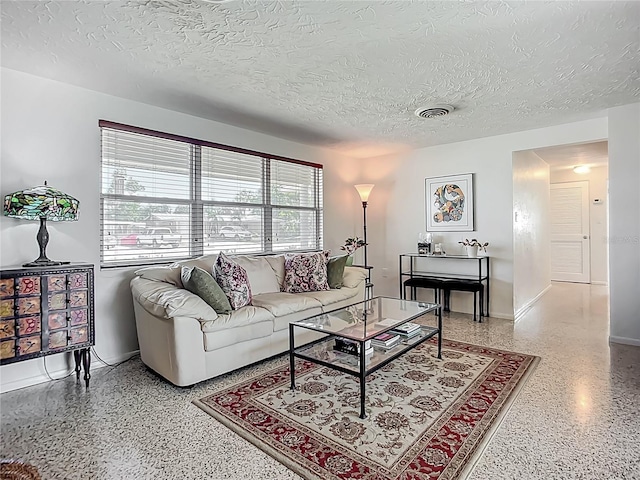 2108 Lee Ln, Sarasota, FL 34231 - living area featuring speckled floor, a textured ceiling, and baseboards