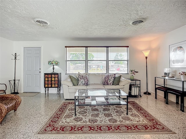 2108 Lee Ln, Sarasota, FL 34231 - living room with speckle patterned floor, a textured ceiling, and baseboards