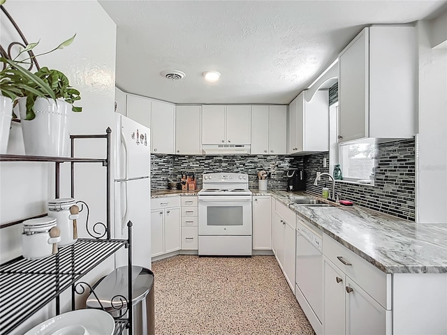 2108 Lee Ln, Sarasota, FL 34231 - kitchen with white appliances, a sink, under cabinet range hood, backsplash, and dark aggregate flooring