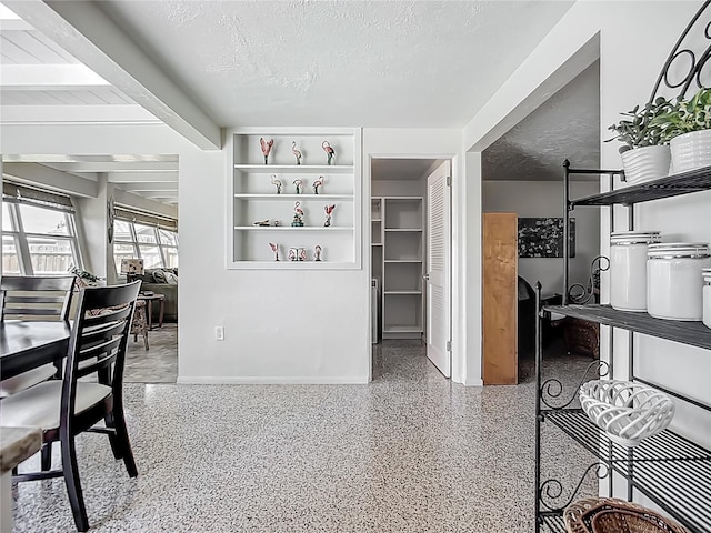 2108 Lee Ln, Sarasota, FL 34231 - hallway with speckle patterned floor, a textured ceiling, and baseboards