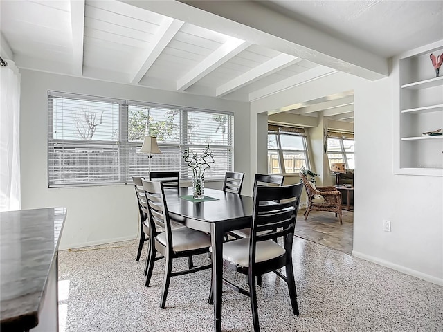 2108 Lee Ln, Sarasota, FL 34231 - dining space featuring baseboards, beam ceiling, and dark aggregate flooring
