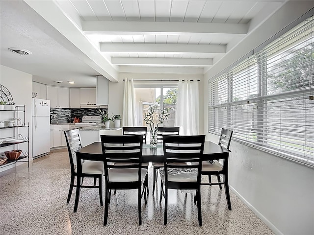 2108 Lee Ln, Sarasota, FL 34231 - dining room with dark aggregate flooring, baseboards, and beam ceiling