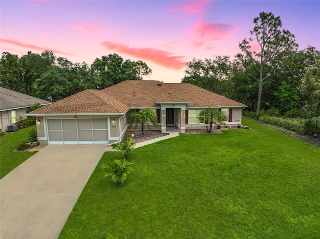 2834 Coolidge Ave, North Port, FL 34286 - mediterranean / spanish-style home featuring driveway, a front lawn, and a garage