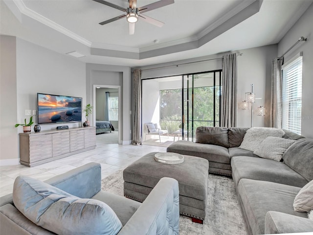 220 Sarezzo Cir, Nokomis, FL 34275 - living area featuring a raised ceiling, ornamental molding, a ceiling fan, and baseboards