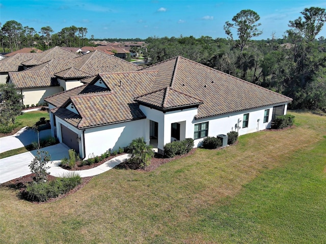 220 Sarezzo Cir, Nokomis, FL 34275 - view of front of home featuring stucco siding, driveway, an attached garage, a tile roof, and a front yard