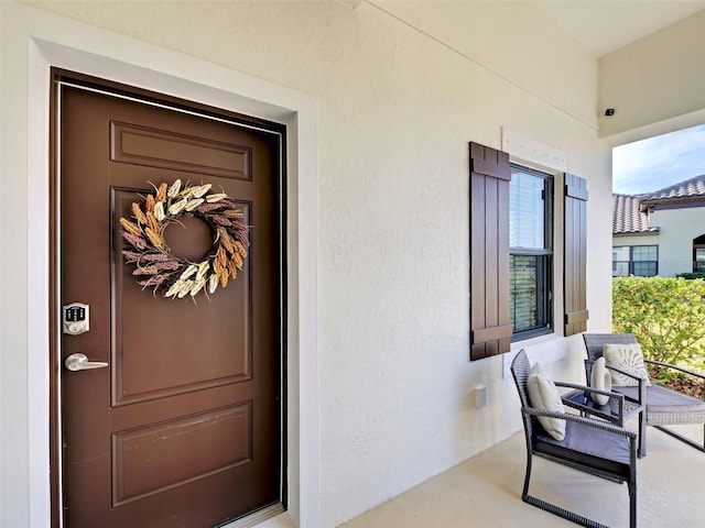 220 Sarezzo Cir, Nokomis, FL 34275 - property entrance with covered porch and stucco siding