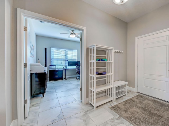 220 Sarezzo Cir, Nokomis, FL 34275 - corridor featuring a desk, baseboards, and light marble finish floors