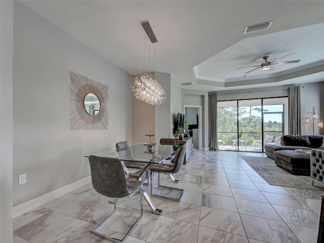 220 Sarezzo Cir, Nokomis, FL 34275 - dining space featuring light marble finish floors, baseboards, a chandelier, ceiling fan, and a raised ceiling