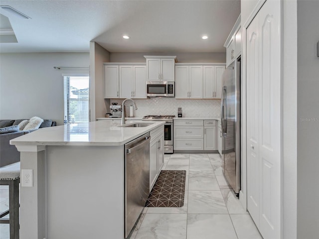 220 Sarezzo Cir, Nokomis, FL 34275 - kitchen featuring stainless steel appliances, light marble finish flooring, a sink, backsplash, and open floor plan